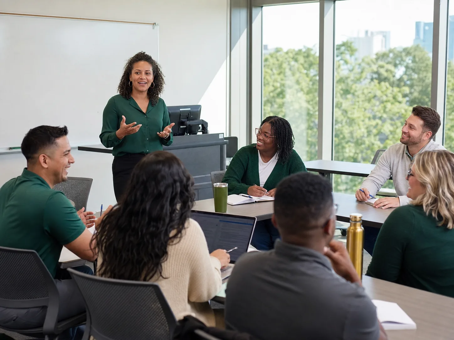 Graduate students taking part in an in-person classroom discussion